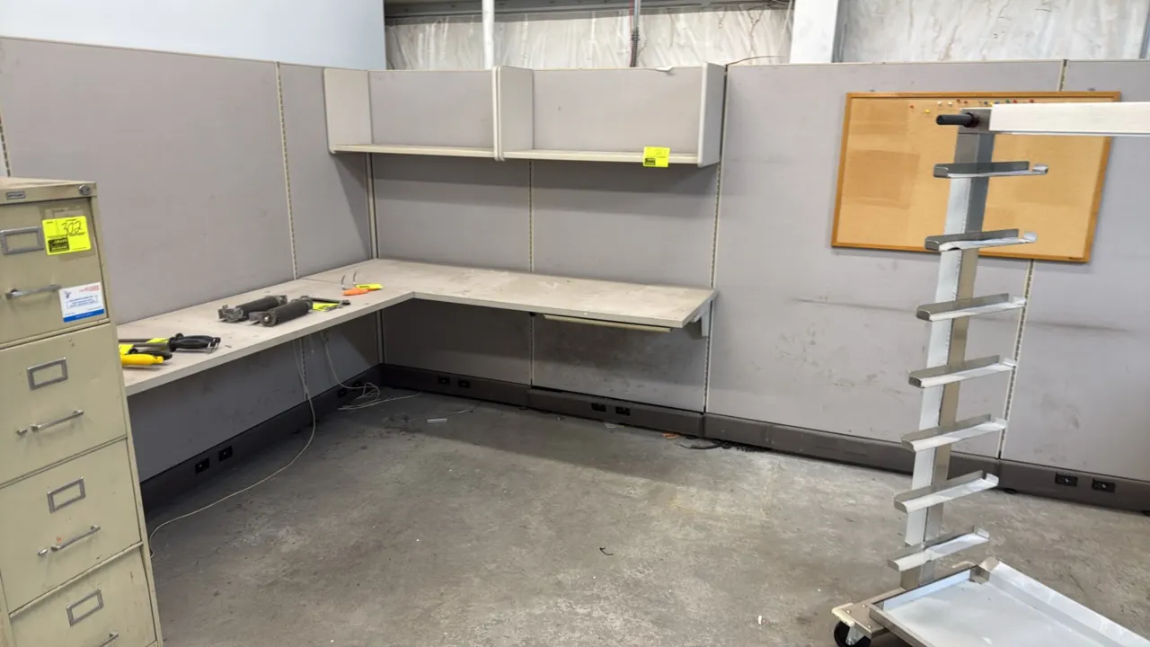Cubicle workstation setup. Includes (6) fabric panels, an L-shaped laminate desktop, and (2) overhead shelves. Features base raceways with electrical/