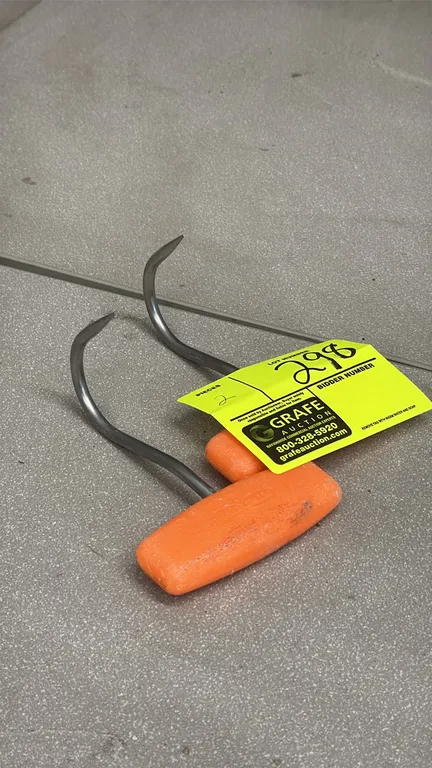 Stainless steel meat hooks. Features curved stainless steel points and molded orange plastic T-handles.