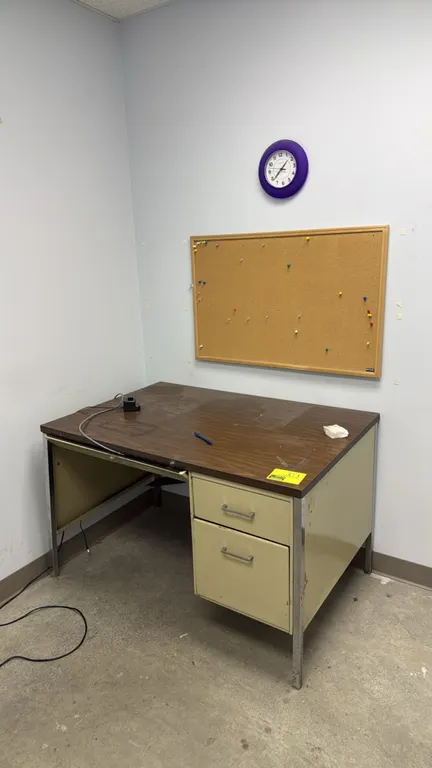 Office lot including a 45" metal desk and 3' framed cork bulletin board. Desk features a woodgrain laminate top, right-side 2-drawer pedestal, and met