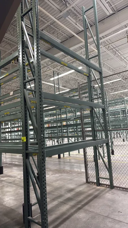 Interlake warehouse pallet racking. Features teardrop-style upright frames, 4" crossbars with safety pins, and green painted finish. Dimensions: 7'6"