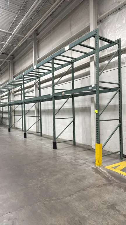 Interlake warehouse racking. Features teardrop uprights, horizontal cross beams, wire mesh decking, and pallet support bars. Includes (1) 7'6"L and (1