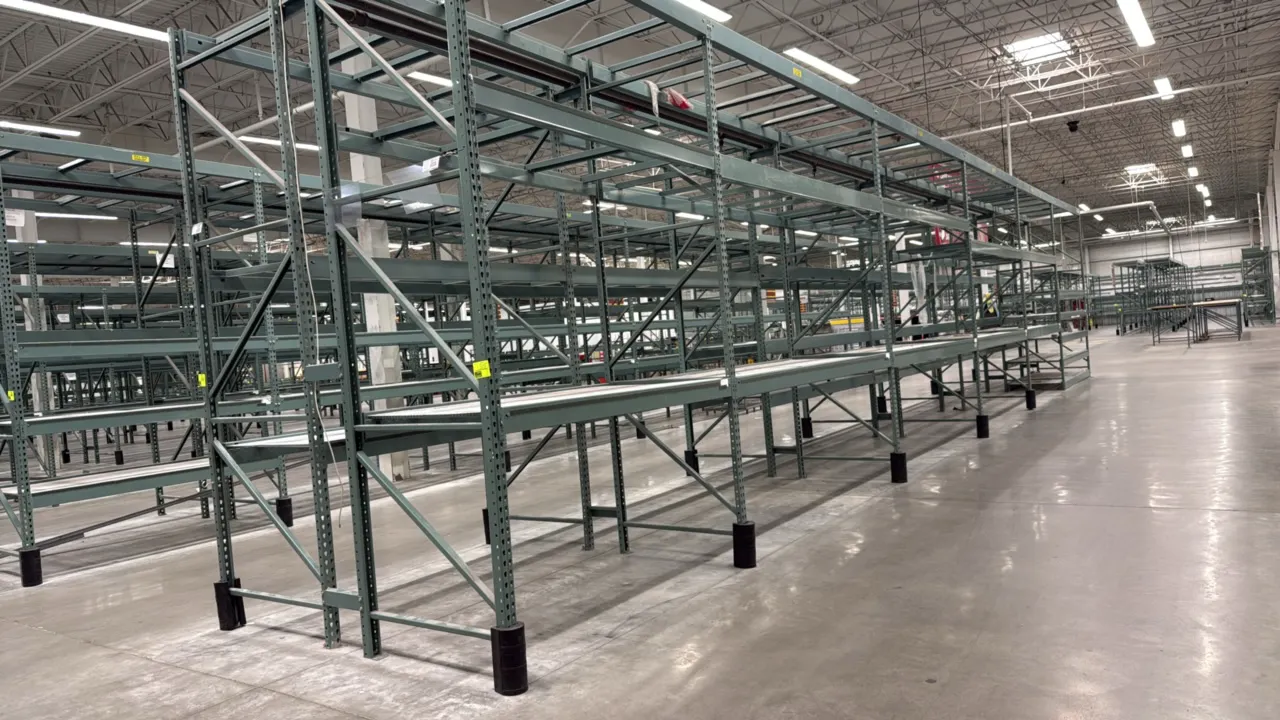 Interlake warehouse pallet racking. Features teardrop-style uprights, load beams, and expanded metal mesh shelf decking. Dimensions: (1) 7'6"L bay and