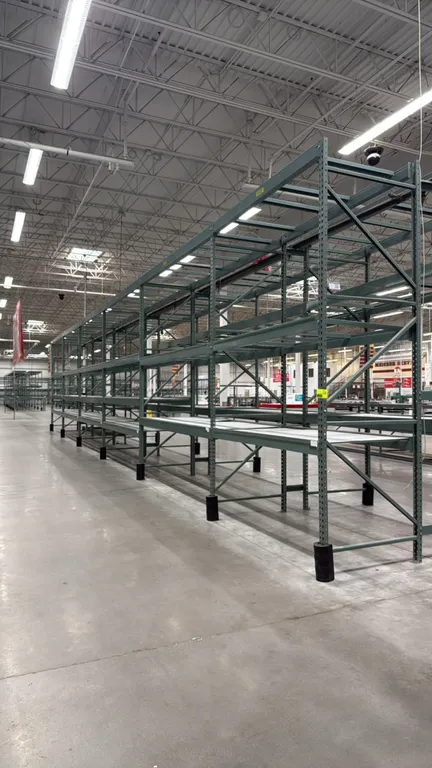 Interlake warehouse racking. Features teardrop uprights, cross beams, pallet support bars, expanded metal wire decking, and green finish. Includes (1)