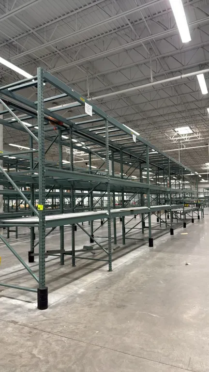 Interlake warehouse pallet racking. Features teardrop uprights, load beams, wire mesh decking, and upper-level lane dividers. Includes (1) 7'6"L bay a