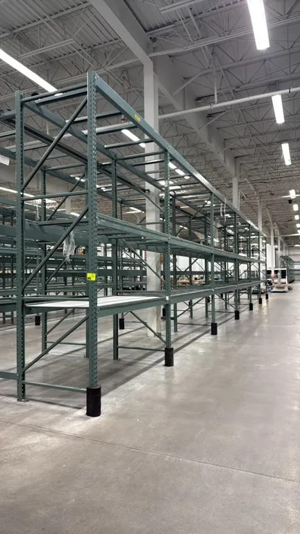 Interlake warehouse pallet racking. Features teardrop-style uprights, load beams, cross support bars, and wire mesh decking. Includes (1) 7'6"L bay an