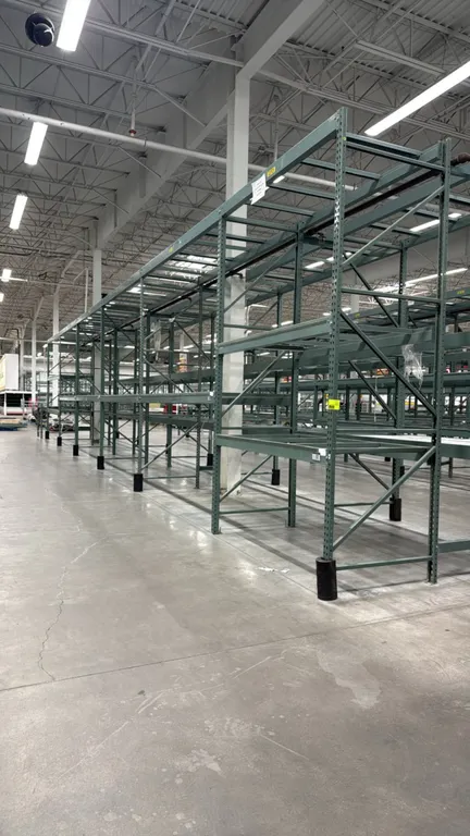 Interlake warehouse pallet racking. Features teardrop uprights, cross beams, pallet support bars, and green finish. Includes (1) 7'6" section and (5)