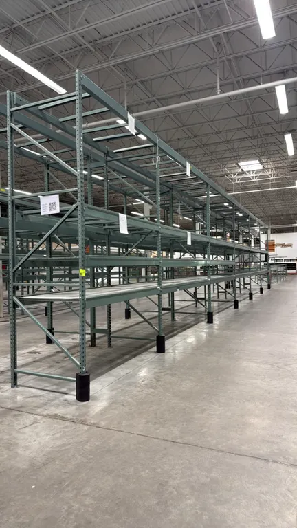 Interlake warehouse pallet racking. Features teardrop uprights, step beams, wire mesh decking, and base column protectors. Includes (1) 7'6"L bay and