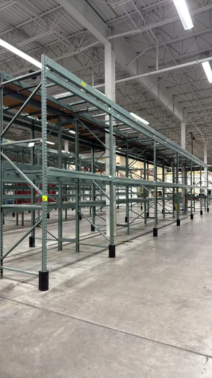 Interlake warehouse racking. Features teardrop upright frames, crossbars, and column base protectors. Includes (1) 7'6"L and (5) 10'9"L sections. Dime