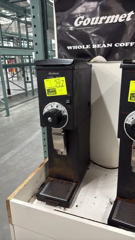 Bunn G3 HD commercial coffee bean grinder. Features multi-setting grind selector dial, bag clamp lever, top-loading bean hopper with lid, and perforat