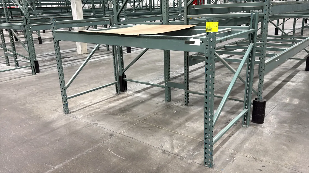 Interlake warehouse pallet racking. Features teardrop-style upright frames, cross beams, and cross support bars. Finished in green. Dimensions: 7'6" x
