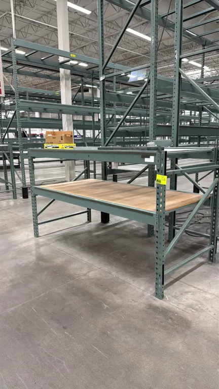 Interlake warehouse pallet racking section. Features teardrop design, (2) uprights, (4) cross beams, upper wire mesh deck, and lower wood decking. Dim