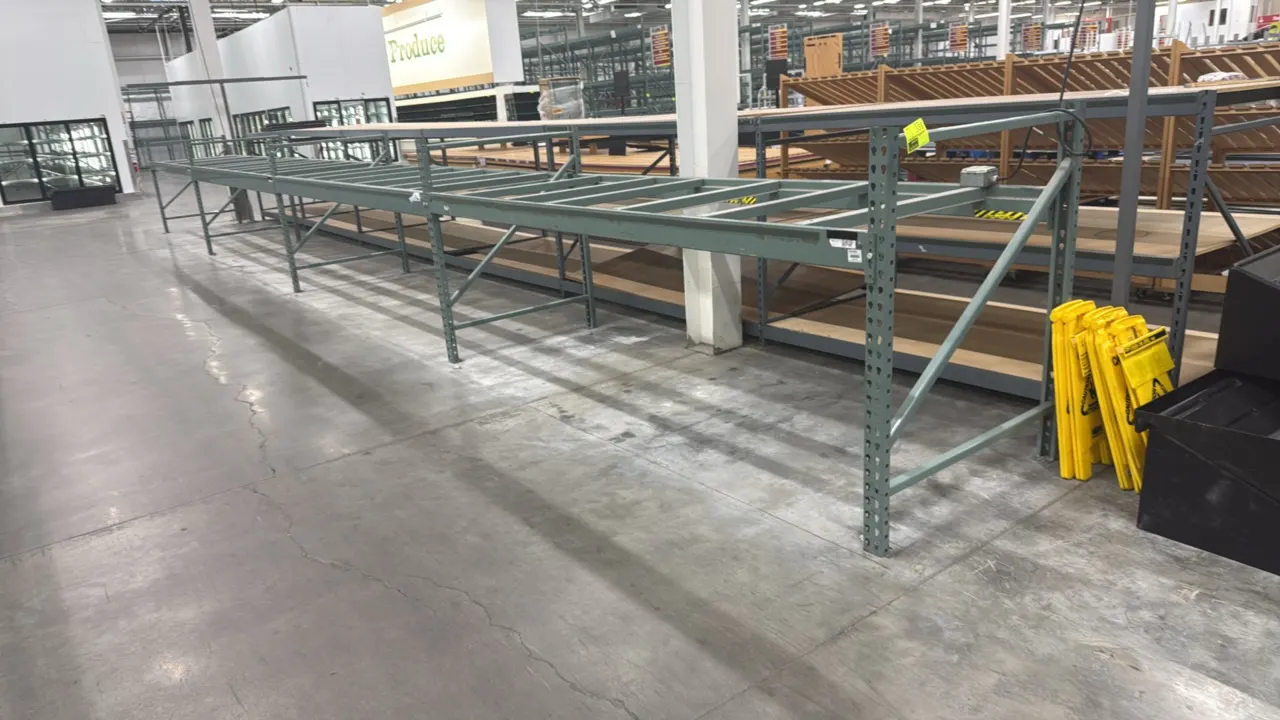 Interlake warehouse racking. Features teardrop-style uprights, horizontal cross beams, pallet support bars, and green finish. Dimensions: 10'9" x 3'8"