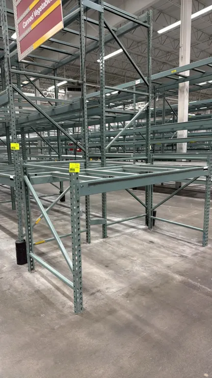Interlake warehouse pallet racking. Features teardrop upright frames, cross beams, and pallet support crossbars. Finished in green. Dimensions: 7'6"L