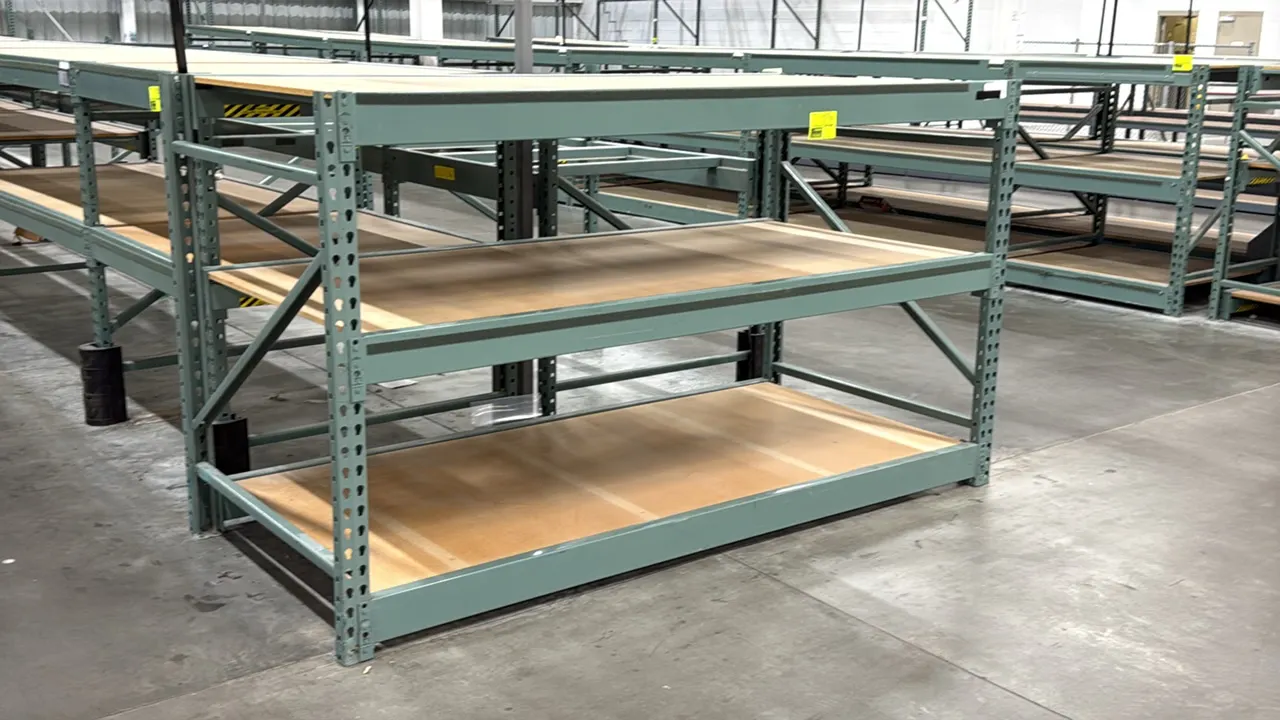 Interlake warehouse racking. Features teardrop upright design, (3) shelf levels, and particle board decking. Finished in green. Dimensions: 7'6"L x 3'