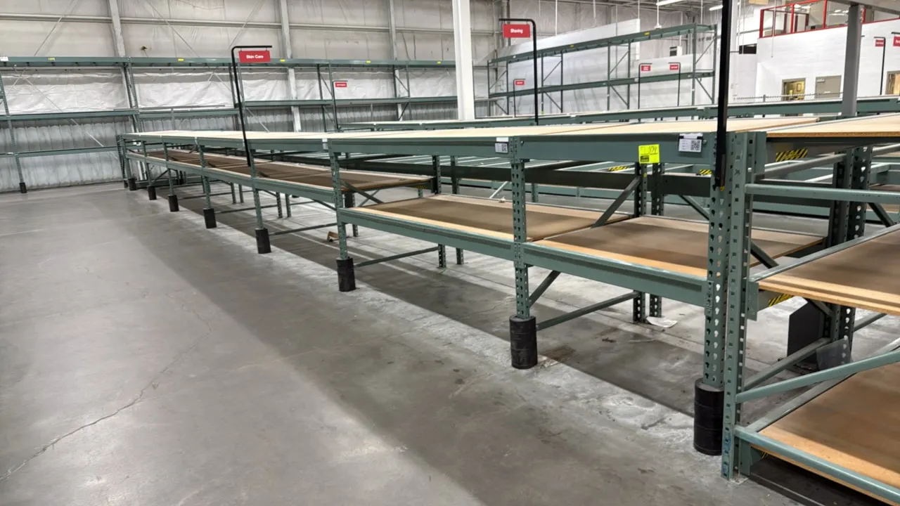 Interlake warehouse racking. Features upright frames, cross beams, wood decking, and green steel construction. Includes (6) 7'6"L sections and (1) 3'9