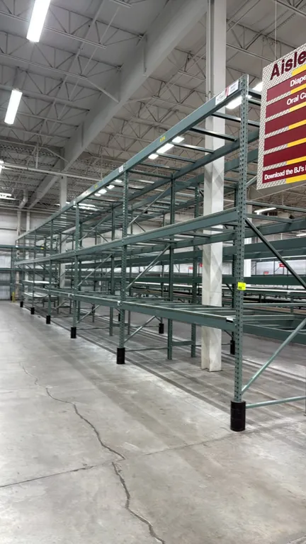 Interlake warehouse racking. Features teardrop uprights, cross beams with safety lock pins, pallet support bars, and green finish. Dimensions: 10'9" x