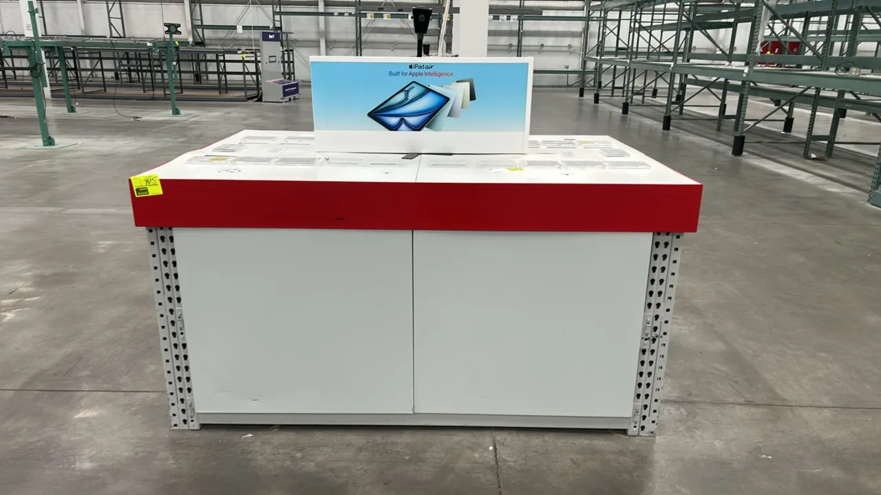 Teardrop warehouse racking retail merchandising display table. Features metal teardrop upright base frame with white side panels, red perimeter trim,
