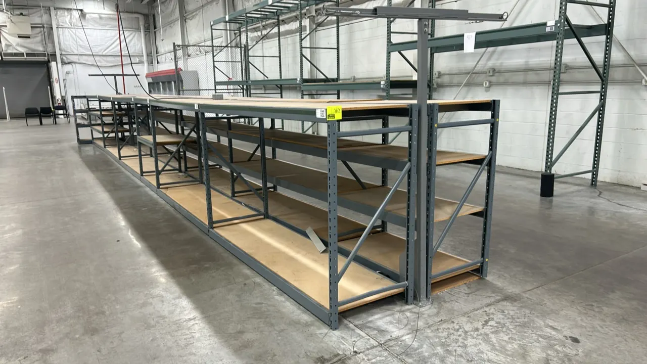 Light-duty metal warehouse racking. Features gray metal frames and (4) shelf levels per section with corkboard decks. Dimensions: (11) 26" x 90" x 54"