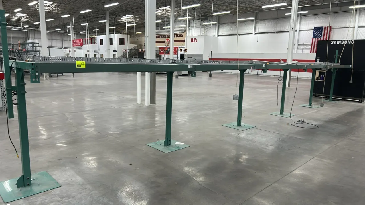 Metal electronic merchandising display rack system with (5) sections. Features green painted steel frame, slotted wire management raceways with covers