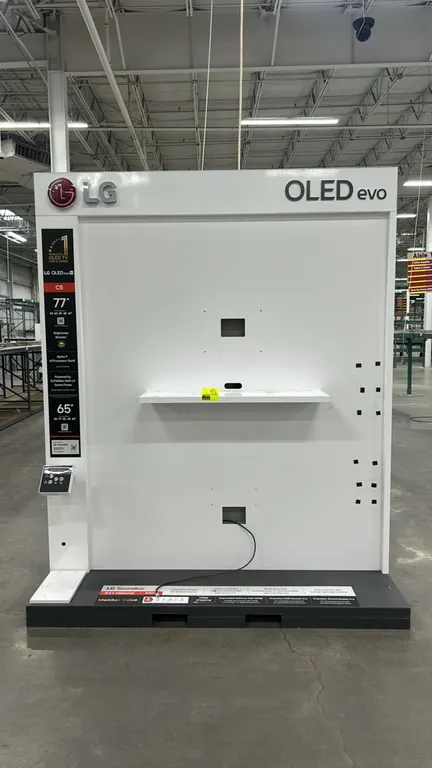 LG OLED retail merchandising display stand. Features metal and laminate construction, LG OLED evo branding, center component shelf, interactive contro