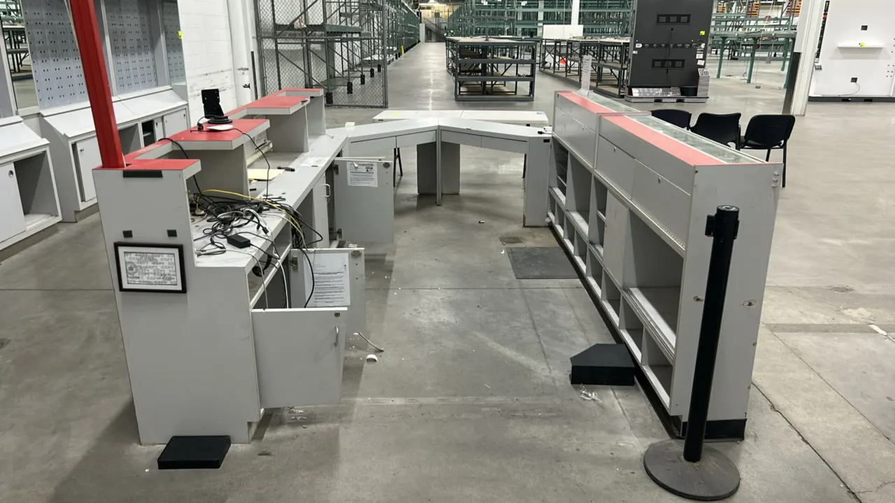 Laminate service counter. Features multi-section configuration with glass display cases, raised transaction counters, lower storage cabinets, open she