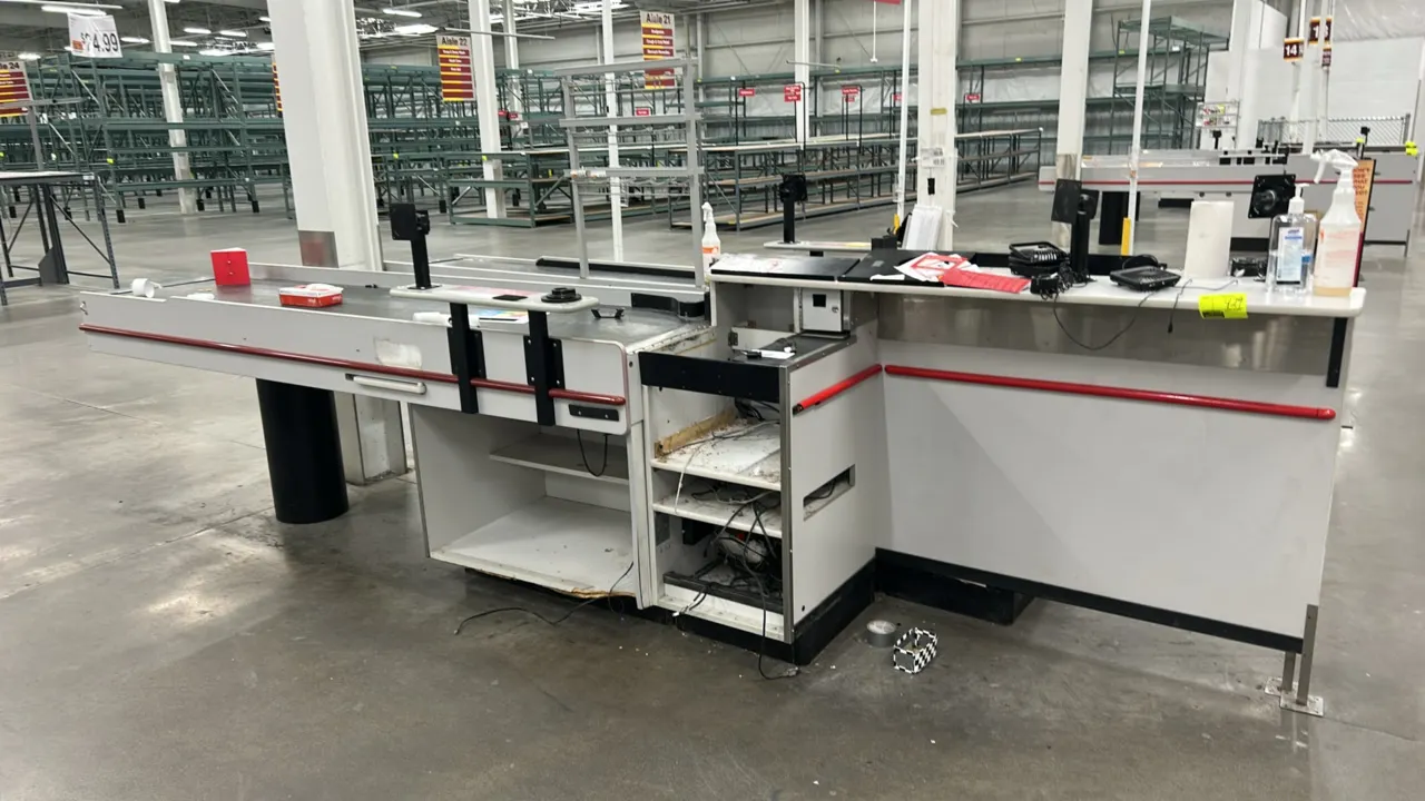 Reynolds UL-2 Series 2-belt laminate checkout lane. Features dual conveyor belts, white laminate finish with red bumper trim, under-counter storage sh