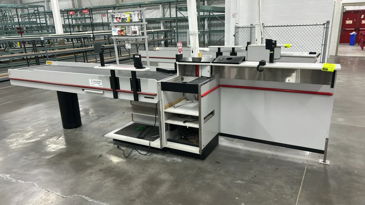 Reynolds UL-2 Series single belt laminate checkout lane. Features motorized conveyor belt, white laminate construction with red bumper trim, check-wri