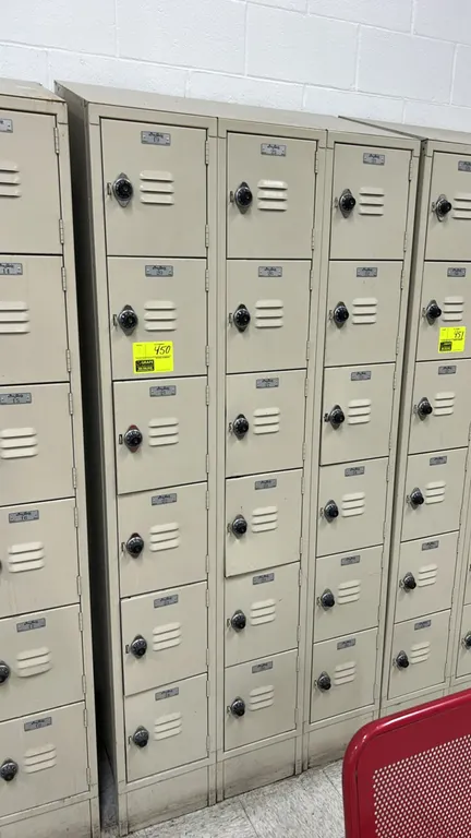 Pro-Quip 6-tier metal employee lockers. Features 6 individual compartments per unit with louvered ventilation, numbered door plates, and built-in comb