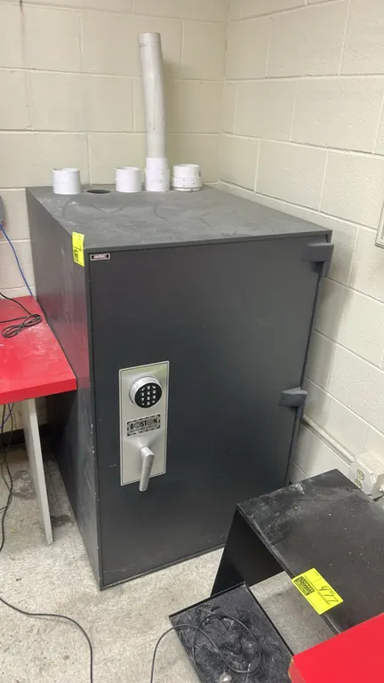 AMSEC security safe. Features Boston Lock & Safe Co. digital keypad lock, lever handle, and exterior hinges. 36" x 30" x 48". Background items not inc
