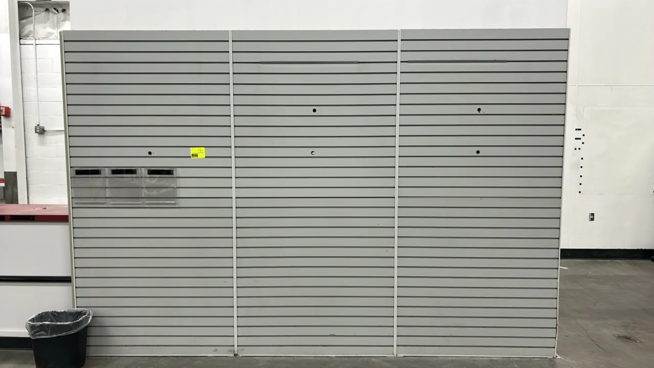 12'L merchandising slatwall display. Features gray grooved panels with vertical divider trim and (3) clear acrylic brochure holders. Trash can and bac