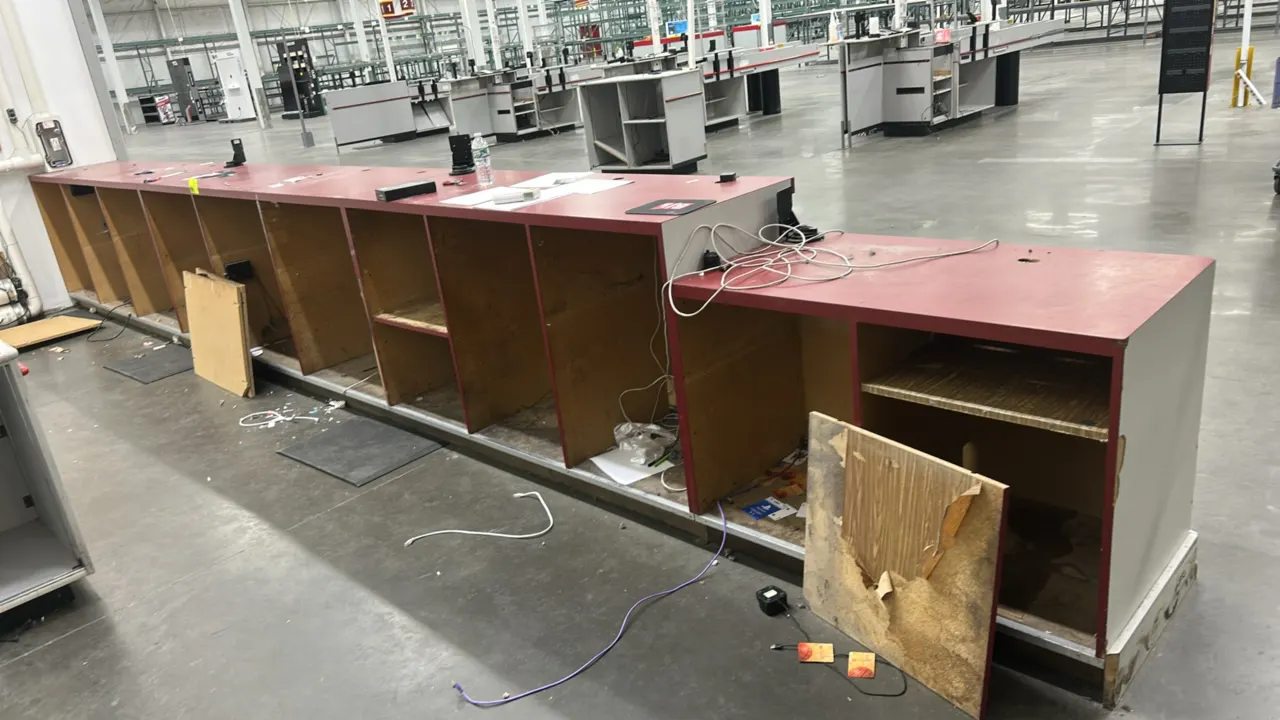 Laminate service counter. Features multi-tier burgundy laminate countertop, white facade with black bumper guard, open rear under-counter storage cubb