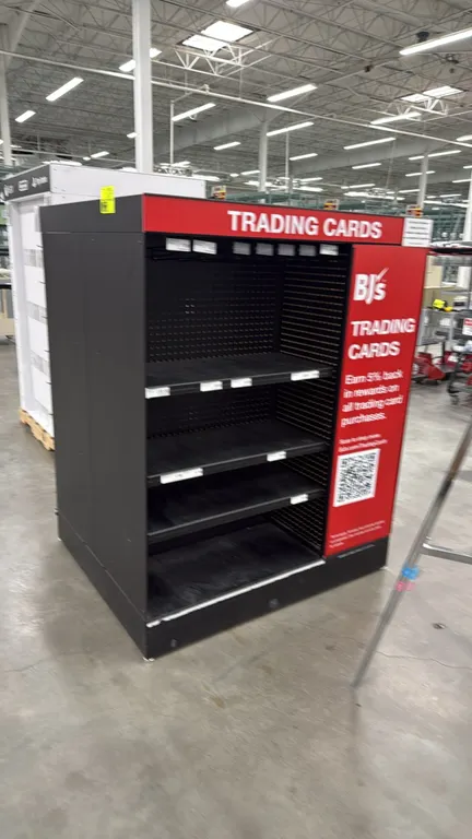4' retail merchandise display rack. Features multi-tier adjustable shelving with integrated shelf label channels, upper pegboard backing, and 'Trading