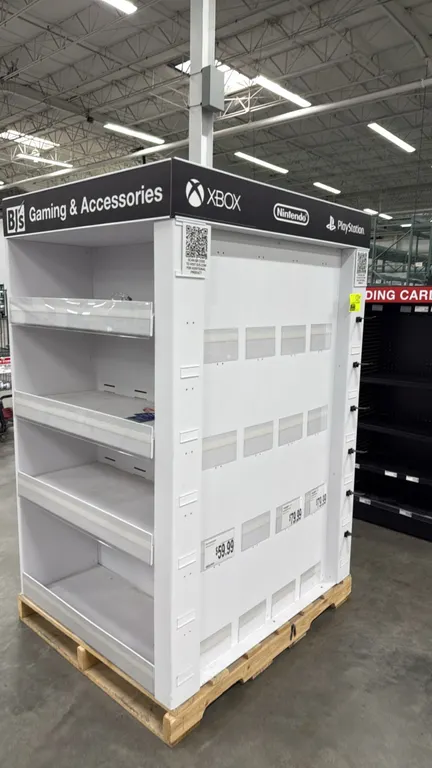 Pallet-sized retail merchandise display rack. Features multi-sided display configuration with 4-tier shelving, retail card display pockets, integrated