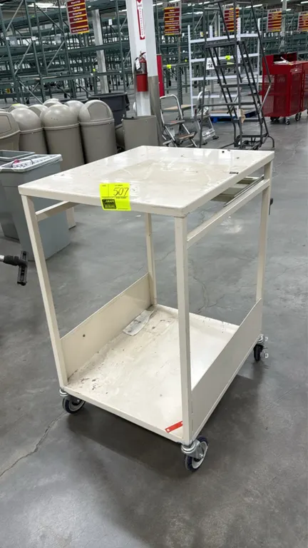 Metal 2-tier utility cart. Features a flat top work surface, slide-out keyboard tray, lower shelf with side retention panels, and tan painted finish.
