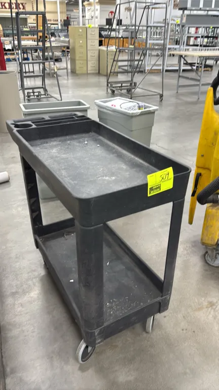Poly 2-tier utility cart. Features molded-in organizer compartments and integrated push handle. 31". Mounted on casters.