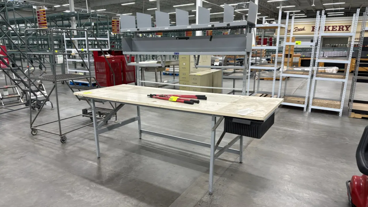 Metal-framed workstation. Features a laminate work surface, under-mount storage bin, and painted metal frame with leveling feet. 96" x 26". Tools and