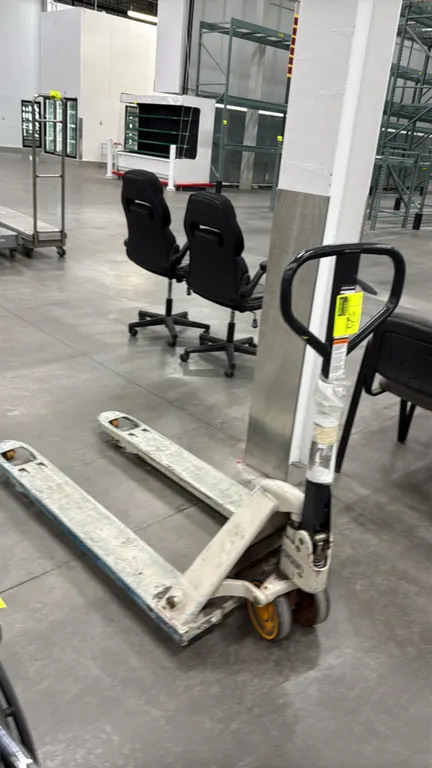 Crown manual pallet jack. Features hydraulic lift, loop steering handle with fingertip release lever, dual steer wheels, and load rollers. Note: Lower