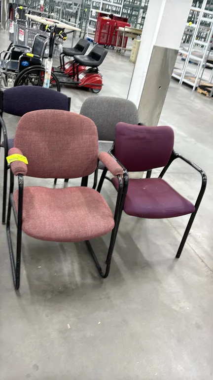 Assorted office side chairs. Features upholstered fabric seats and backrests in assorted colors with integrated armrests. Mounted on black metal frame