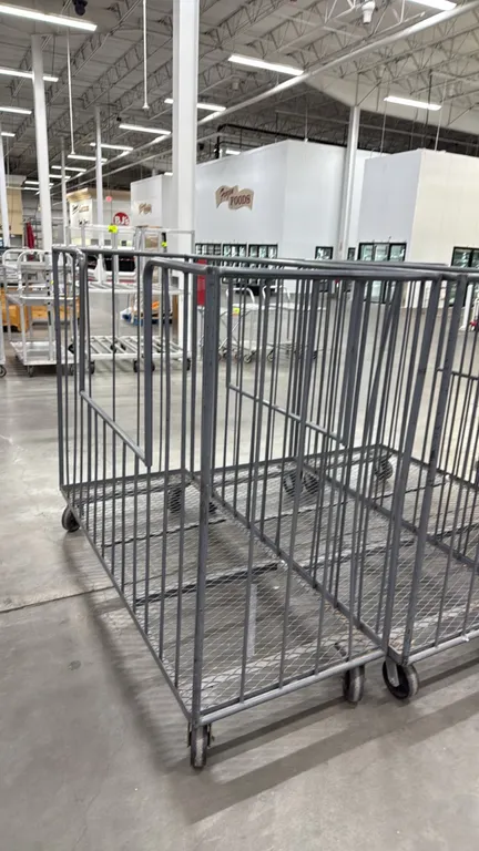 Metal trash carts. Features tubular steel construction, vertical bar sides with front load cutouts, and expanded metal base decks. 6'. Mounted on cast