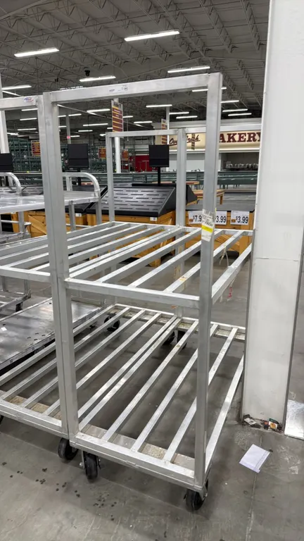 Aluminum 2-tier dunnage carts. Features welded aluminum frame construction with two slatted shelf tiers. 63". Mounted on casters.