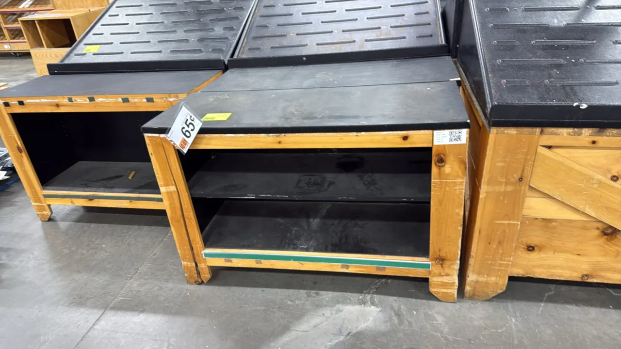 Wood produce dump tables. Features wood construction, black display tops, open lower shelf storage, and lower bumper trim. Dimensions: 4' x 1.5'. Surr