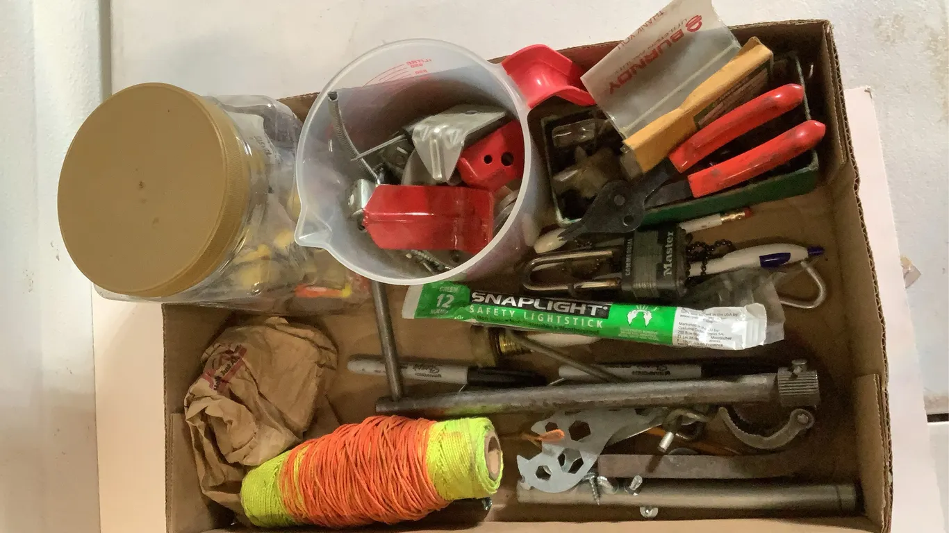Drill bit heads, snap rings, sink wrench, snap light, ear plugs, nylon string