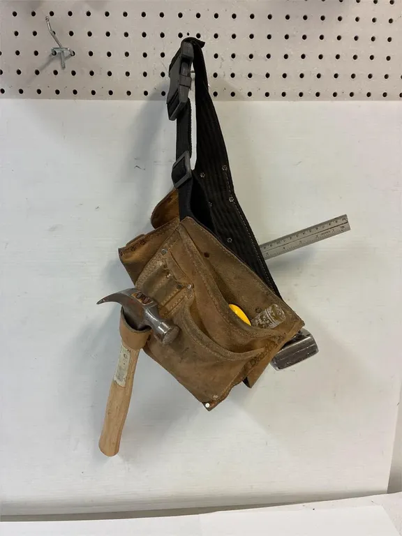 Leather tool belt with tools.