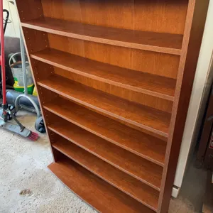 wooden multimedia storage tower, featuring a medium oak finish with multiple adjustable shelves.