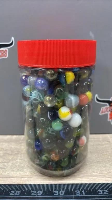 6.5” Plastic Kraft Container Full of Marbles.