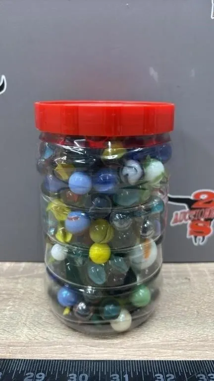 6” Plastic Kraft Container Full of Marbles.