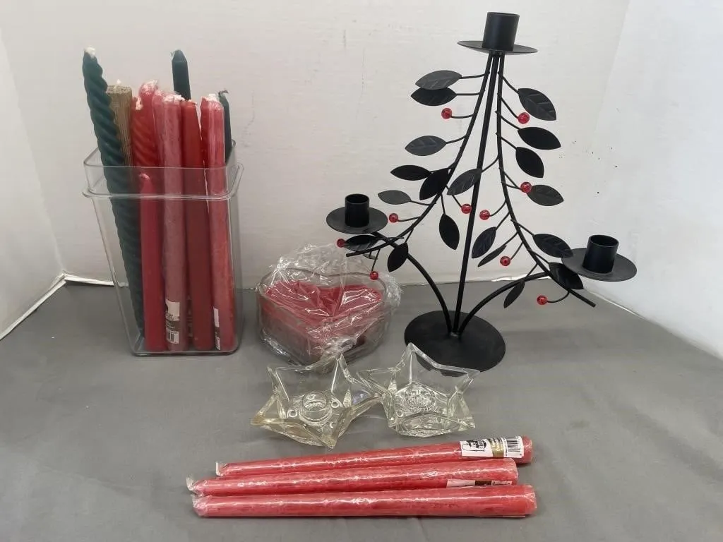 Variety of taper candles, glass candlestick