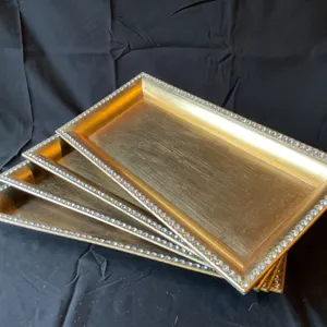 Four Gold Rectangular Trays with Decorative Borders