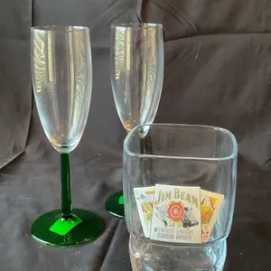 Three-Piece Glassware Lot Featuring Jim Beam Glass and Green-Stem Champagne Flutes