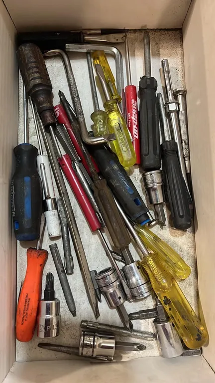 Mixed box of small screw drivers and bits